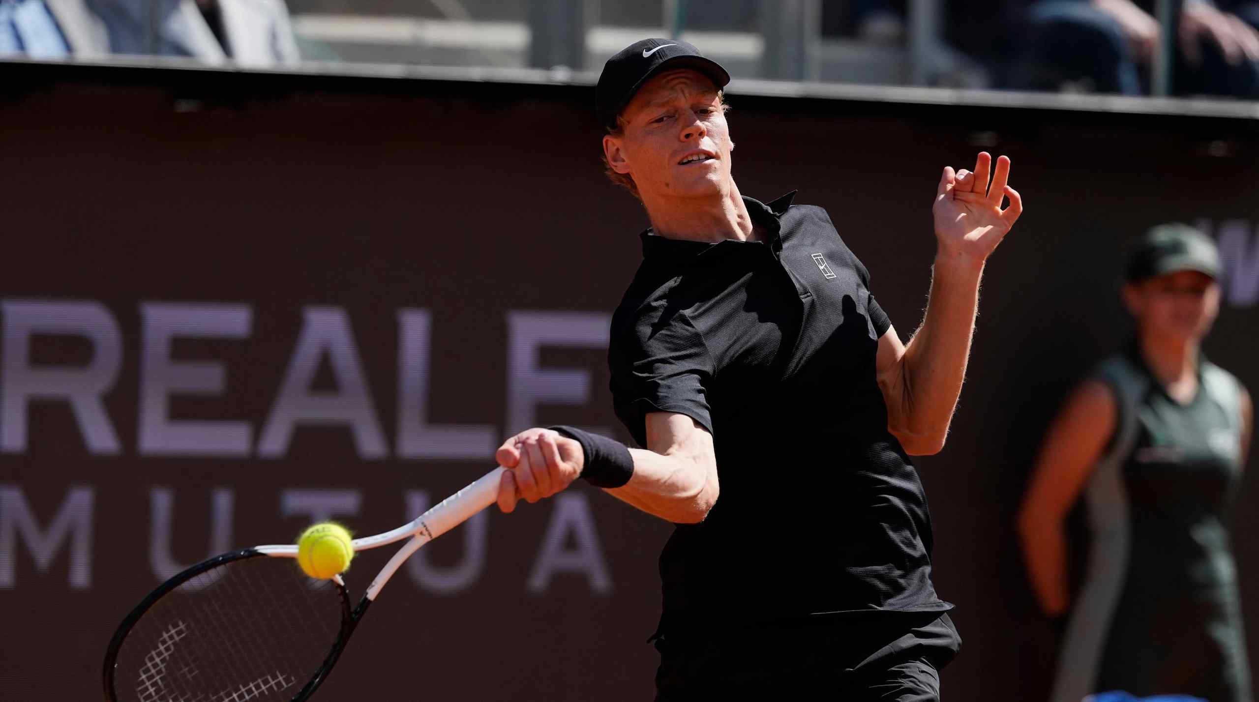 World No. 1 tennis player Jannik Sinner in the middle of a swing.